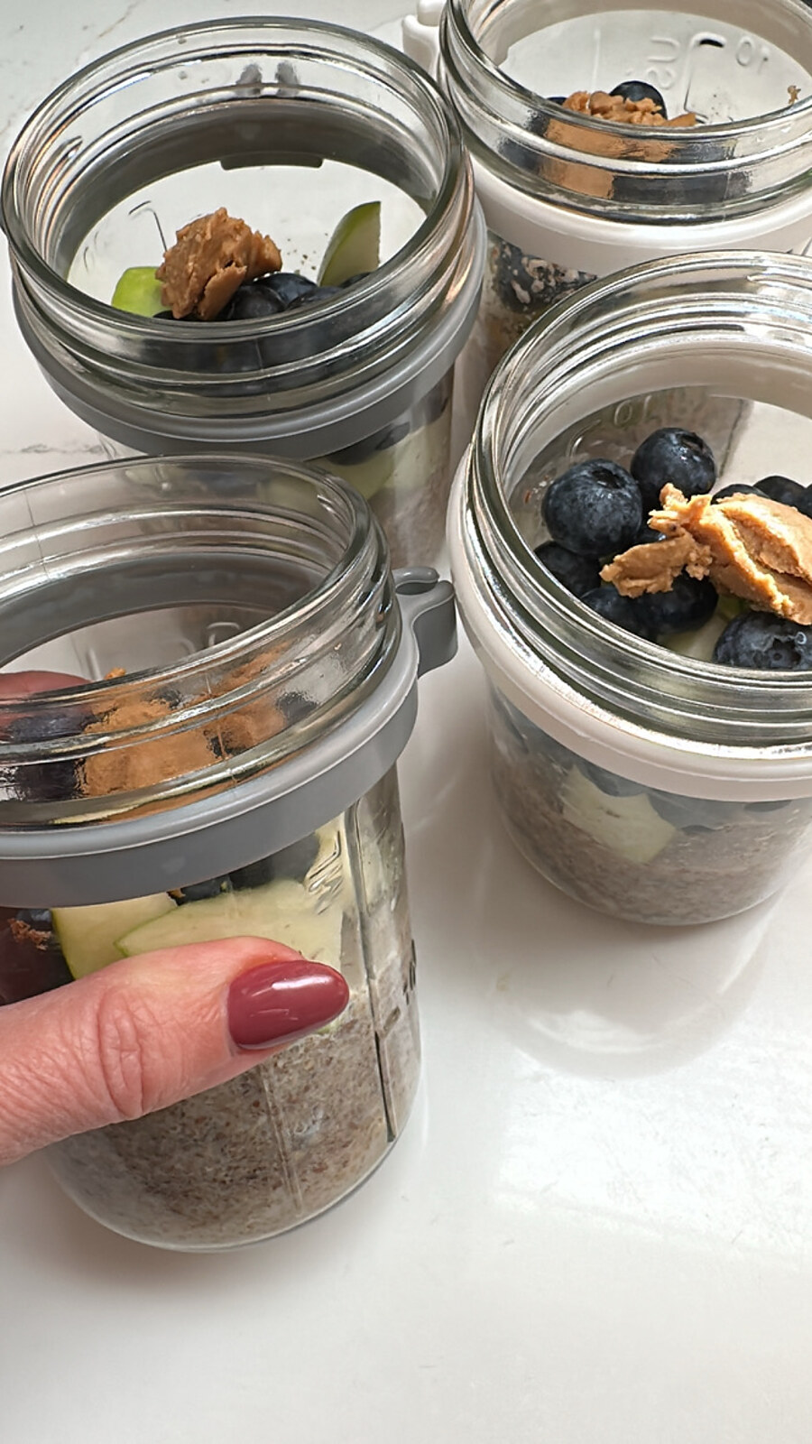 Bowl of creamy steel-cut oats topped with fresh berries and a spoon of almond butter